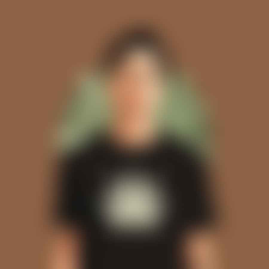 Person wearing a t-shirt with a painted weed leaf design.